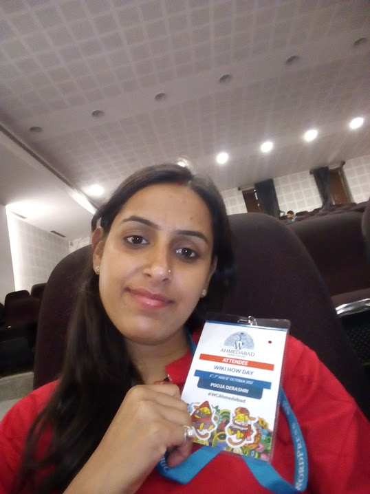 Pooja with a WordCamp Ahmedabad badge